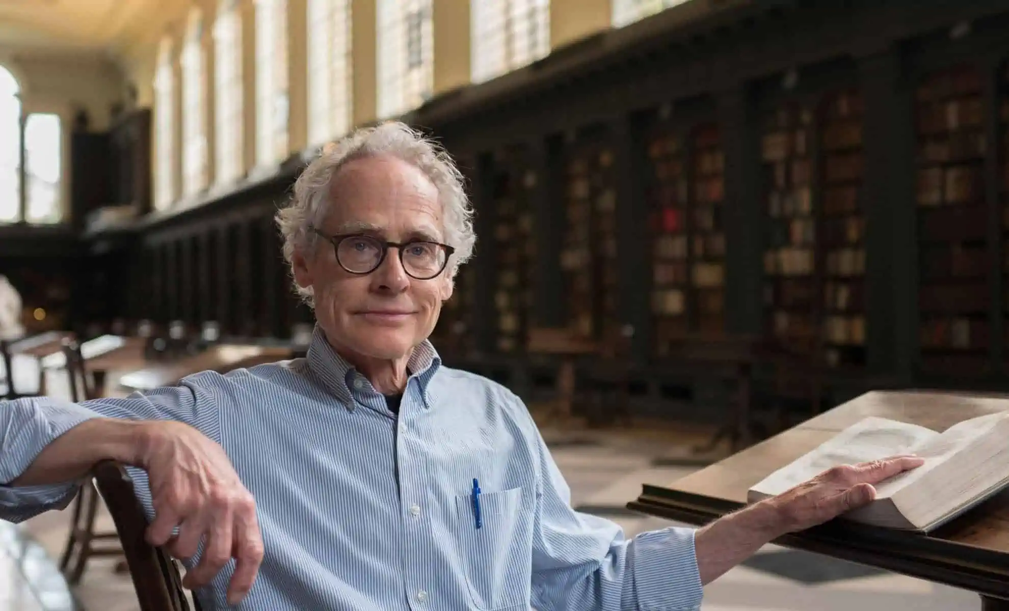 An image of Professor Peter Railton sitting in a library.